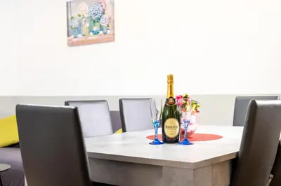 a table with a bottle of champagne and two glasses at HolidayHomeNazzarena in Rome