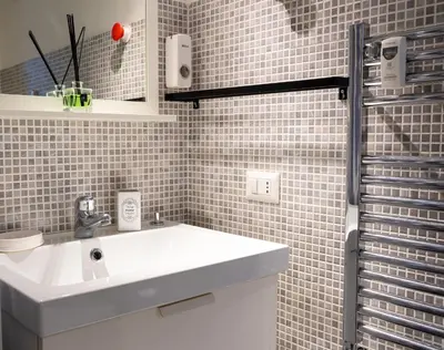 a bathroom with a white sink and a shower at HolidayHomeNazzarena in Rome