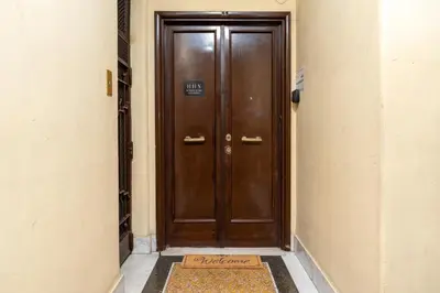 a wooden door in a hallway with a sign on it at HolidayHomeNazzarena in Rome