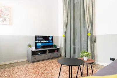 a living room with a tv and a table at HolidayHomeNazzarena in Rome