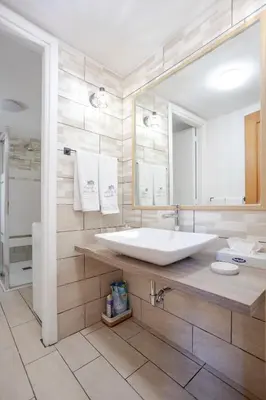 a bathroom with a large sink and a large mirror at Home d'Elite Trevi Fountain in Rome