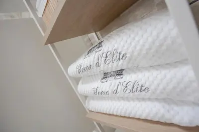 a stack of white towels sitting on a shelf at Home d'Elite Trevi Fountain in Rome