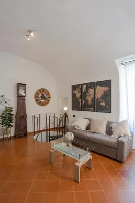 a living room with a couch and a table at Home d'Elite Trevi Fountain in Rome