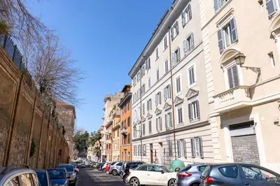 a city street with parked cars and buildings at The 62 Home l Homkeey Apartments in Rome