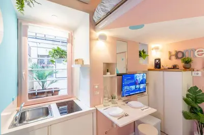 a kitchen with a sink and a desk and a window at The 62 Home l Homkeey Apartments in Rome