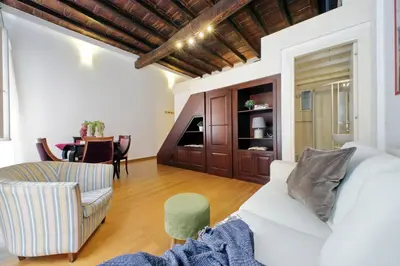 a living room with a white couch and a table at Borgo Comfortable Loft in Rome