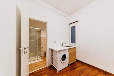 a bathroom with a washing machine and a sink at Monferrato Home in Rome
